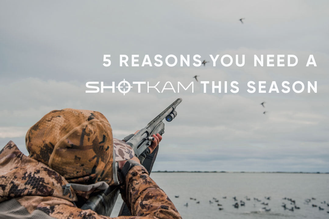 Close-up of hunter’s perspective with shotgun raised, flock of ducks in background, ShotKam on barrel.
