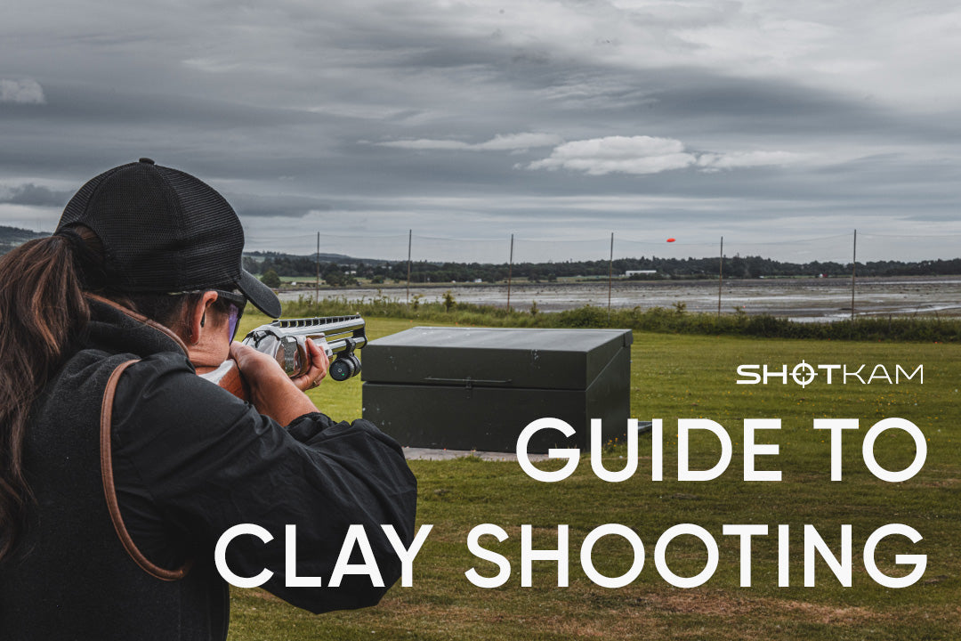 Shooter aiming at an orange clay pigeon during an outdoor ShotKam session