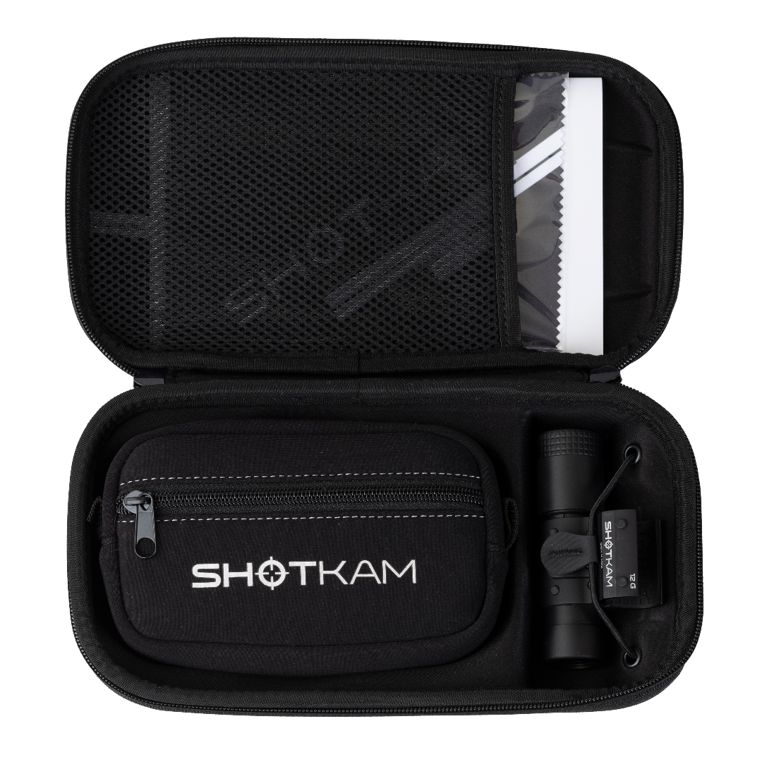 ShotKam Gen 4 Mini camera and accessories neatly organized inside a protective black carrying case with zippered compartments and a mesh pocket.