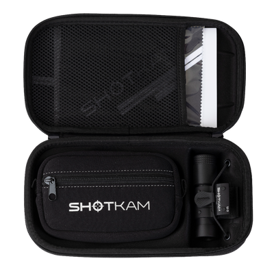 ShotKam Gen 4 Mini camera and accessories neatly organized inside a protective black carrying case with zippered compartments and a mesh pocket.