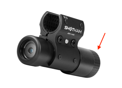 ShotKam Gen 4 Mini camera with a 12 Gauge mount, featuring a red arrow pointing to the back cap that protects the USB-C port from water damage.